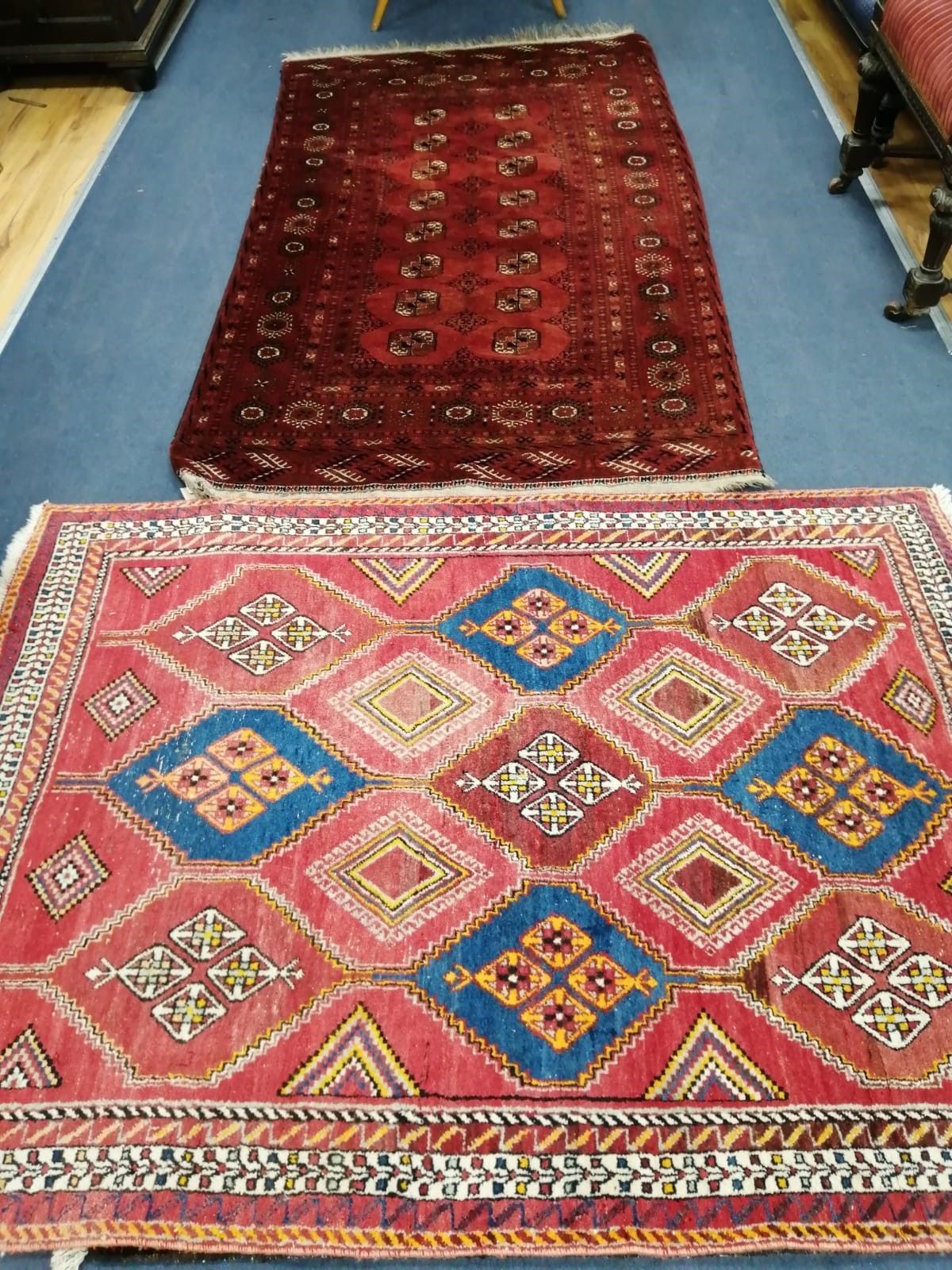 A Bokhara burgundy rug, 200 x 115cm together with a Caucasian design brick red ground rug, 164 x 122cm